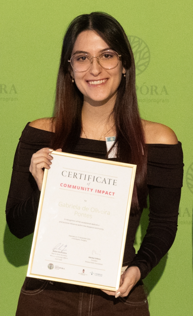 Gabriela holds her Certificate for the Diaspora Scholarship Impact Award 