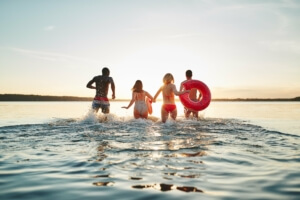 people bathing and running into the water