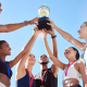 winning team raising a winner cup together